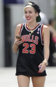 Here's a picture of Miley  Cyrus calling "the ghetto" to find out when the rest of her outfit will be delivered.